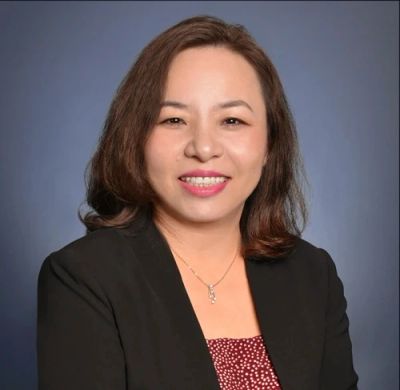 Professional woman smiling in a formal portrait.