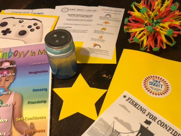 A colorful desk with educational and playful items including a star, a bottle, and booklets.