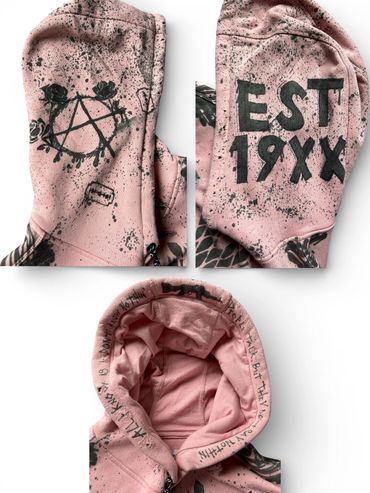 Pink hoodie with black graffiti patterns and text, featuring an anarchy symbol and "EST 19XX".