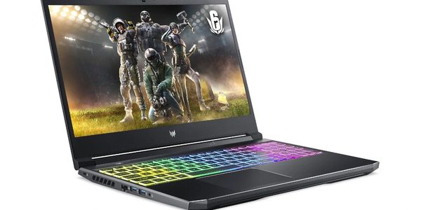 Gaming laptop with colorful RGB keyboard and Rainbow Six Siege wallpaper.
