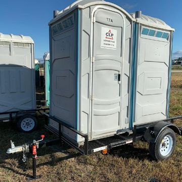 Two porta-potties on a jobsite trailer at a chicken farm.
