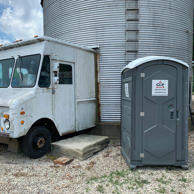 Truck and Toilet near a silo