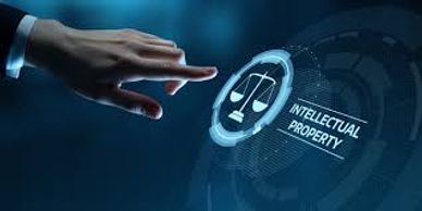 Hand interacting with a digital interface labeled Intellectual Property with scales symbol.