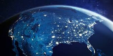 Nighttime satellite view of the United States with city lights glowing.