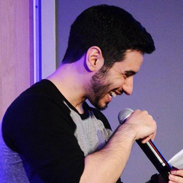 Photo of justPEREZplay hosting an event with a microphone.