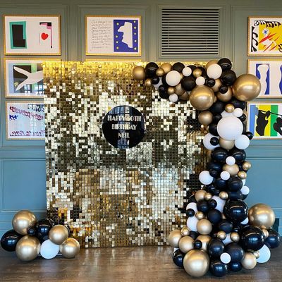Gold sequin wall hire with black, white and gold balloons 