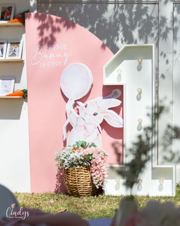 Decorative setup for a first birthday with a bunny theme.