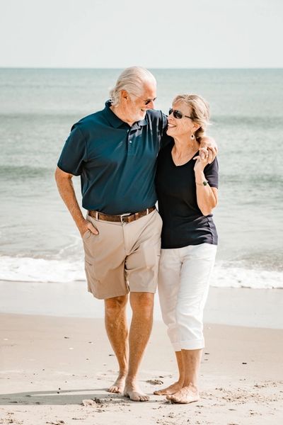 an elderly couple looking at each other 