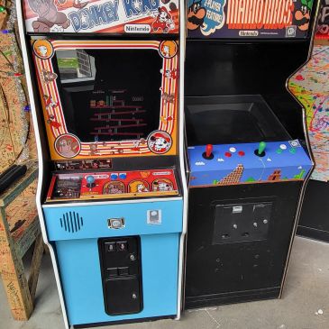 Classic Donkey Kong and Mario Bros arcade machines side by side.