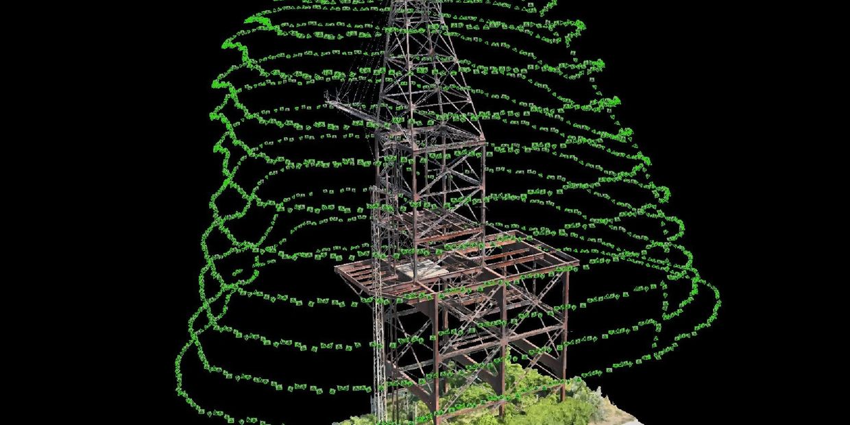 3D reconstruction of a tower with green camera positions spiraling around it.