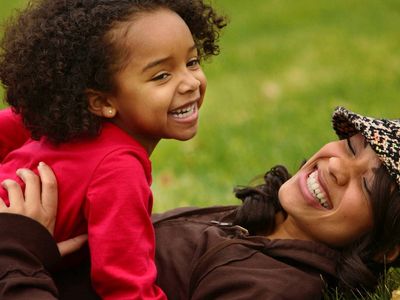 a woman and her child is smiling 