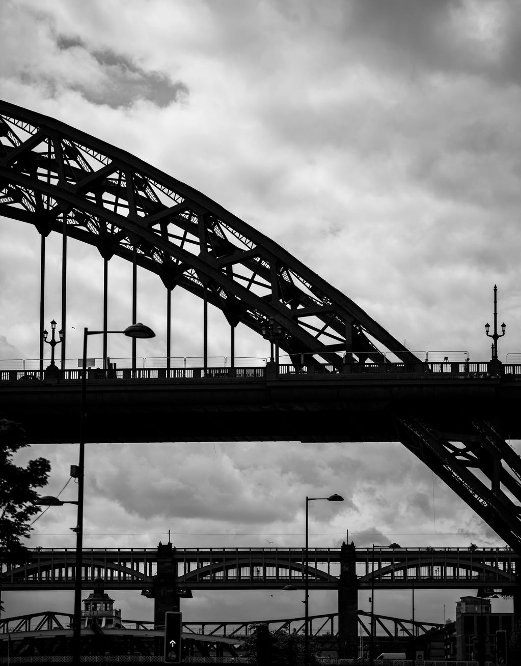 Vertical Black and White picture, showing the bridges in Newcastle, spanning the Tyne River. 