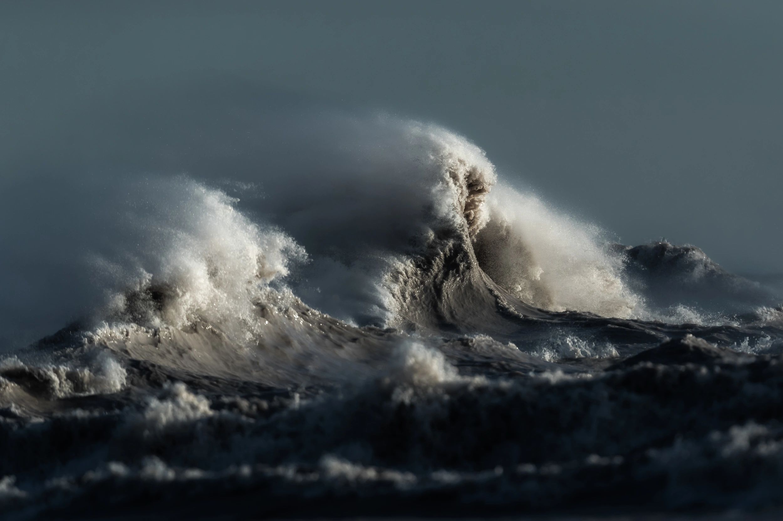 A colour landscape images showing two large waves on Lake Erie during a storm. 