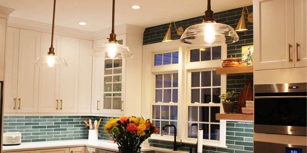 A kitchen with two windows and a sink