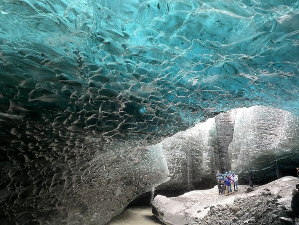 Ice cave under a glacier during a student tour in Iceland.