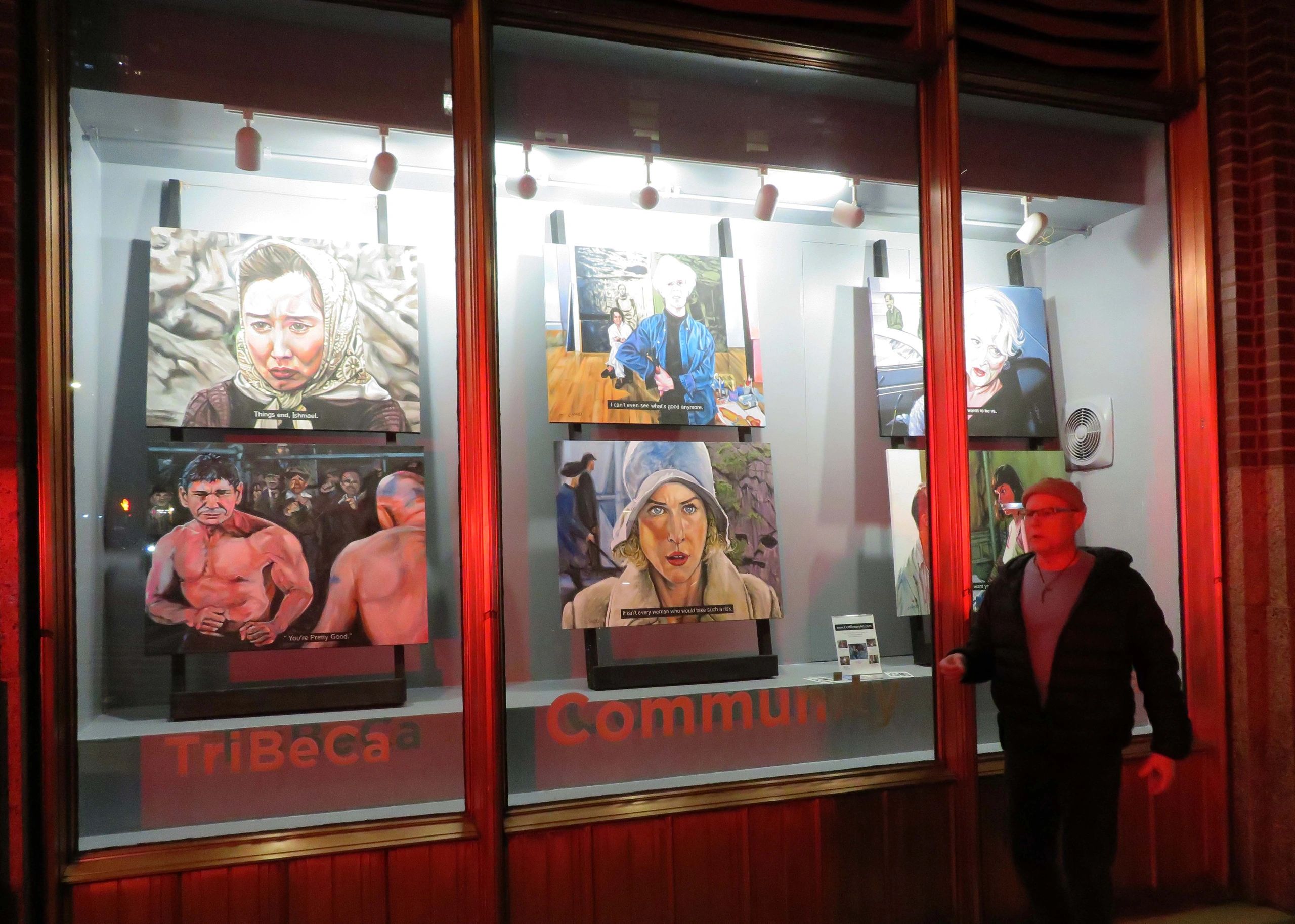 Gallery window showing various paintings and a person outside.