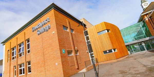 Exterior view of Southport College building with brick and wooden facade.