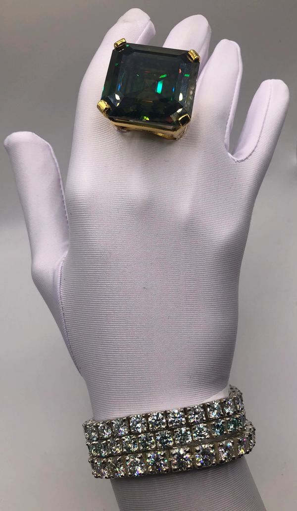 a hand with white gloves and a diamond ring 