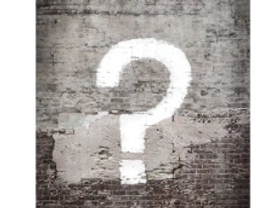 White question mark drawn on brickwall