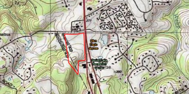 Topographic map showing terrain and structures with highlighted area.
