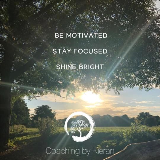 Inspirational message under a sunlit tree with a scenic landscape.