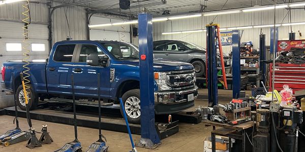 This is our service bay at Wolverine Tire and Autocare with vehicles getting worked on.