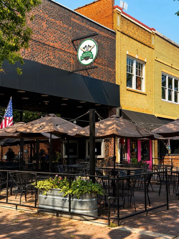Outdoor patio seating of a restaurant under umbrellas.