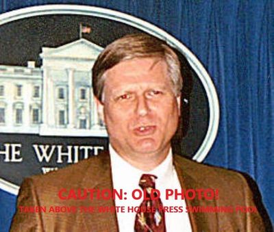 Dennis Brewer at White House press room podium image.