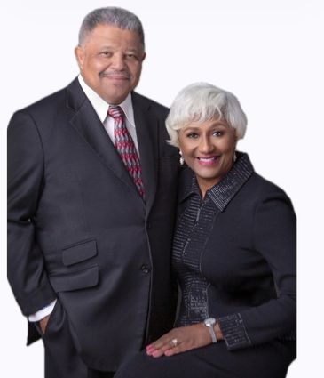 Elegant older couple dressed in formal attire.