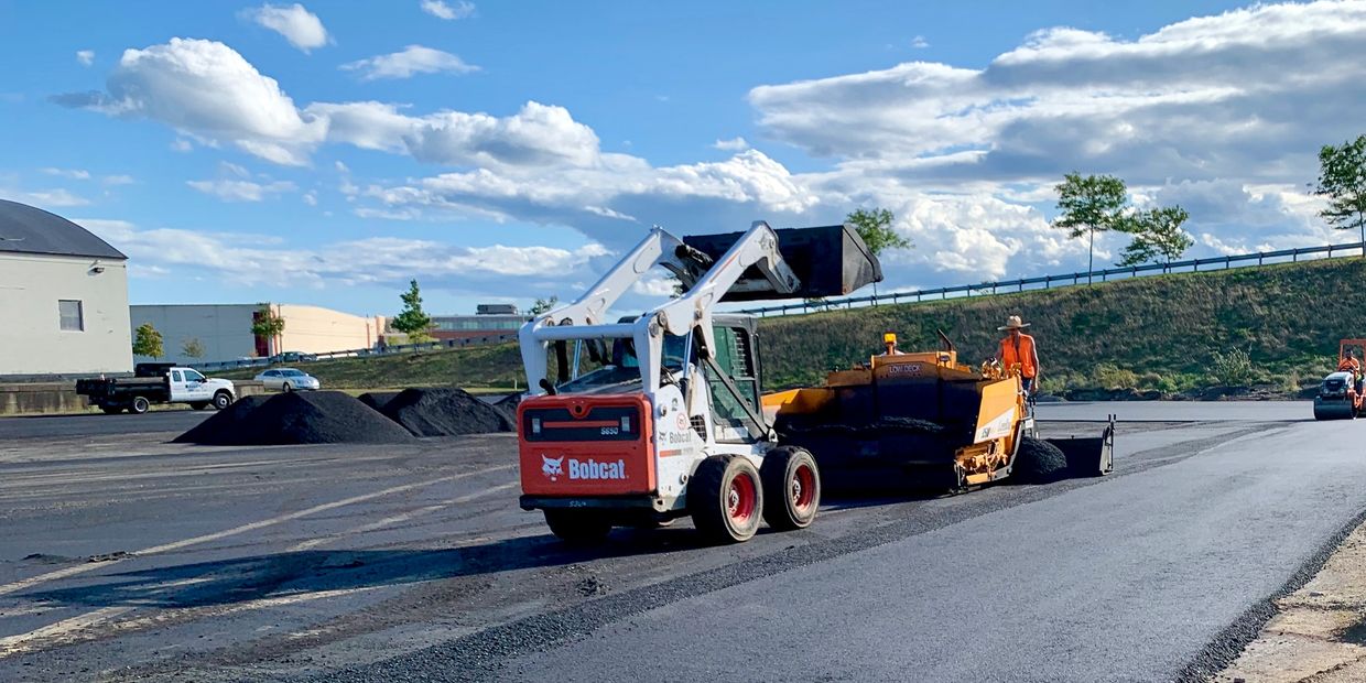Road construction with machinery and workers.