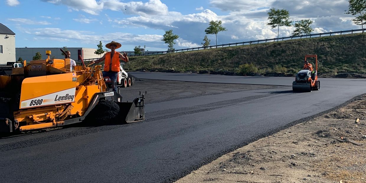 Road construction with heavy machinery and workers.