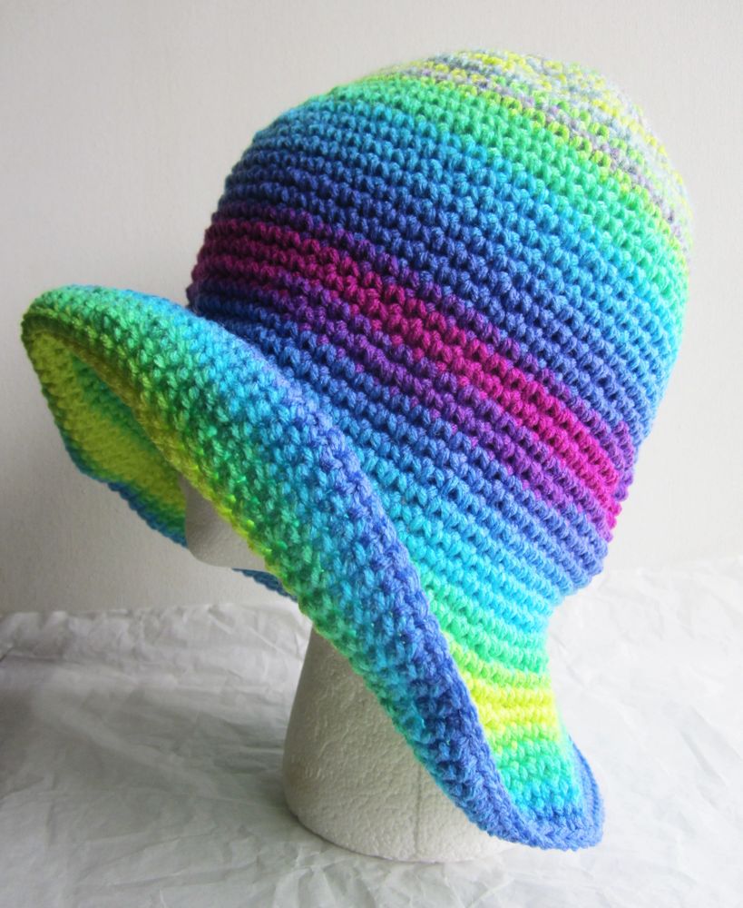 Colorful crocheted hat with a wide brim displayed on a mannequin head.