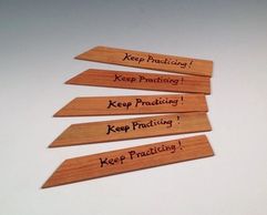 simon leach throwing sticks that say keep practicing