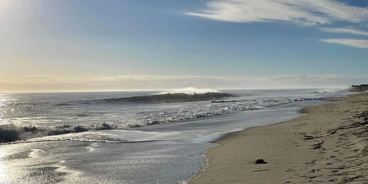 Sun rising in beautiful blue sky over Rehoboth Beach.
