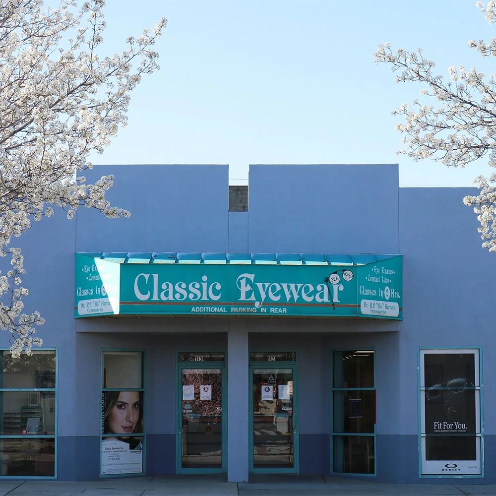 Classic Eyewear store with blooming trees in front.