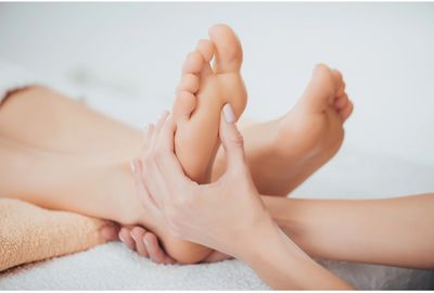 gentle pressure applied to feet by reflexologist