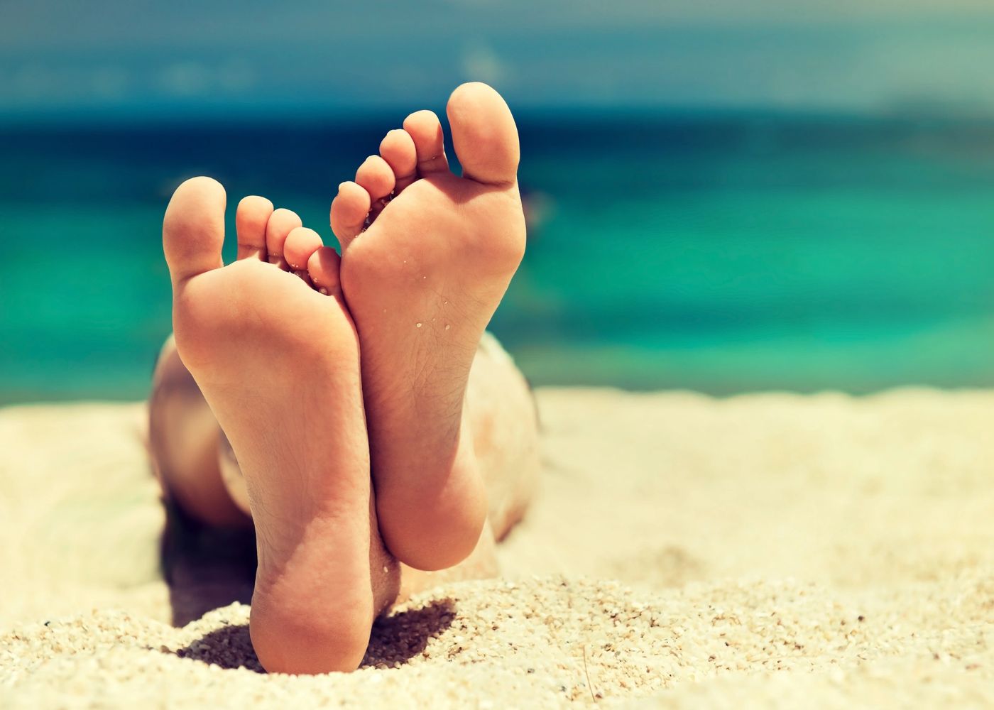 bare feet relaxing on a beach