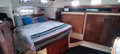 Cozy cabin bed with patterned blanket and pillows.