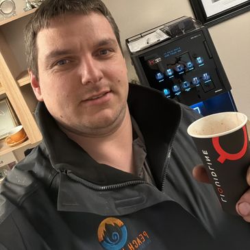 Man holding a coffee cup indoors.