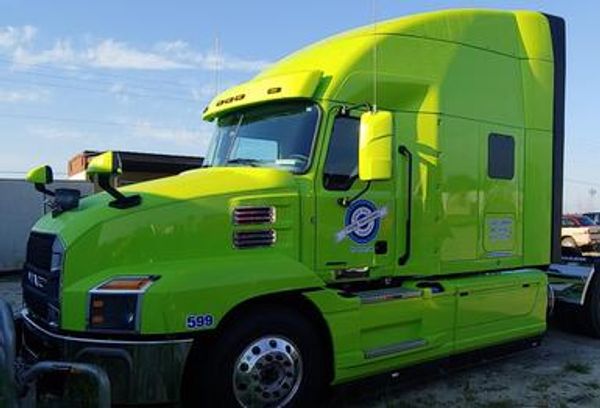 Lime green Mack semi-truck profile.

White Truck: White Volvo semi-truck parked outdoors.