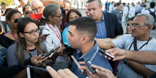 Reporters getting story from an adult Elian Gonzalez