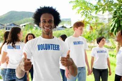 male volunteer holding two thumbs up