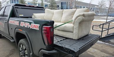 Cluttered outdoor furniture awaiting junk removal in Calgary