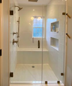 Glass shower door with oil rubbed bronze hardware