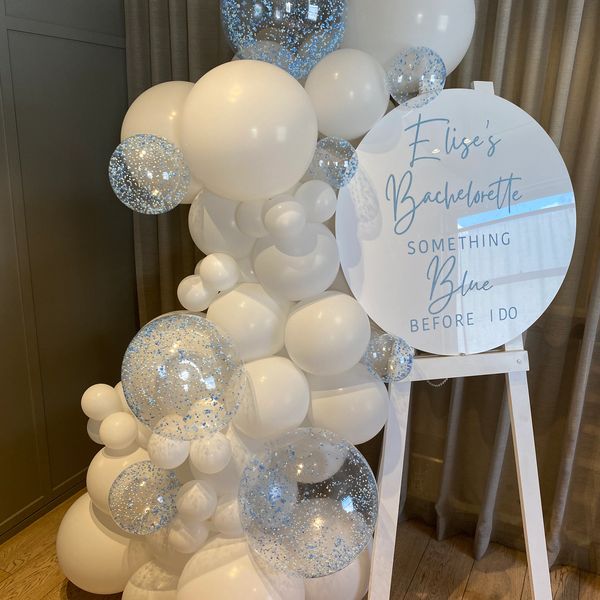 Balloon garland with sign and easel.