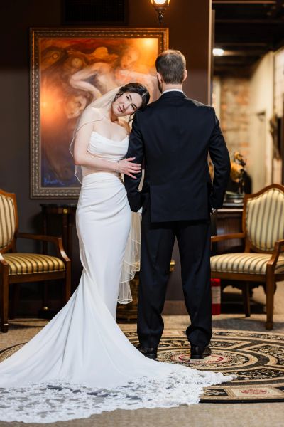 Bride leans on groom's shoulder in an elegant indoor setting at Gallery Forty-Two in Indianapolis, Indiana by Photog Boss, LLC 