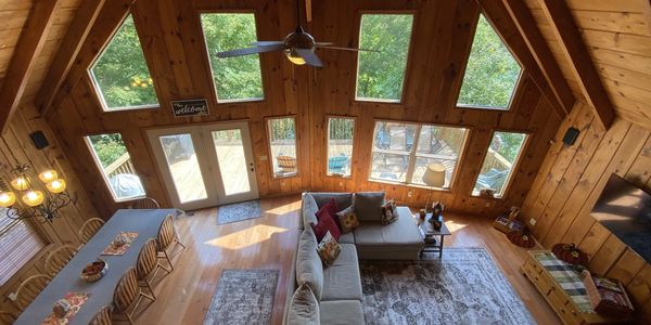 Shore to Please offers a beautiful great room accented with knotty pine and floor-to-ceiling windows.