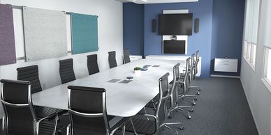 Modern conference room with a large white table and black chairs.