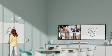 Modern conference room with video call and abstract art.