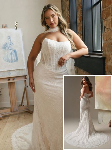A woman modeling a strapless lace wedding gown with a train.